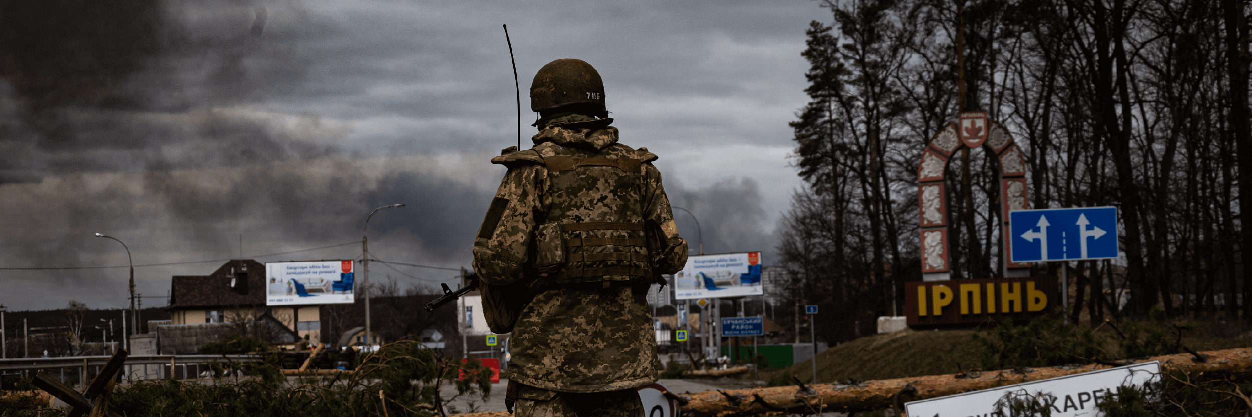 Ukrainian soldier looking over destructions in Irpin, Ukraine